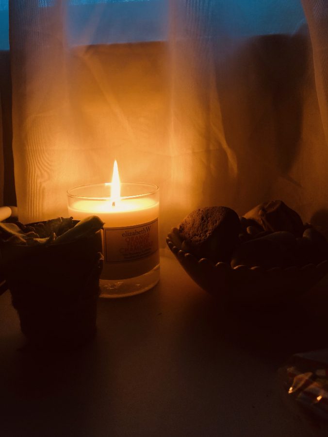 a+picture+of+my+favorite+candle+sitting+dangerously+close+to+my+curtains+and+my+bowl+of+rocks.