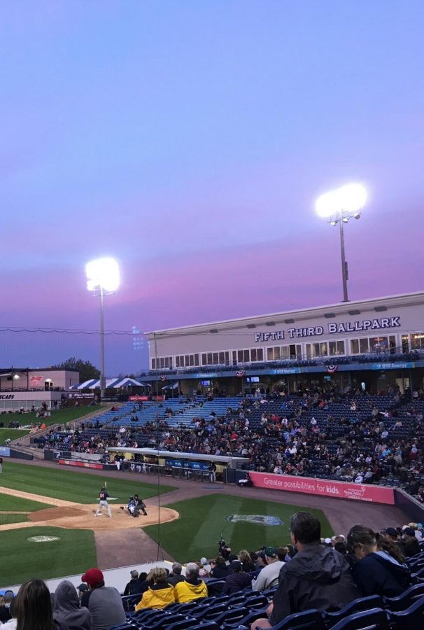 A sun setting at a baseball game last summer
