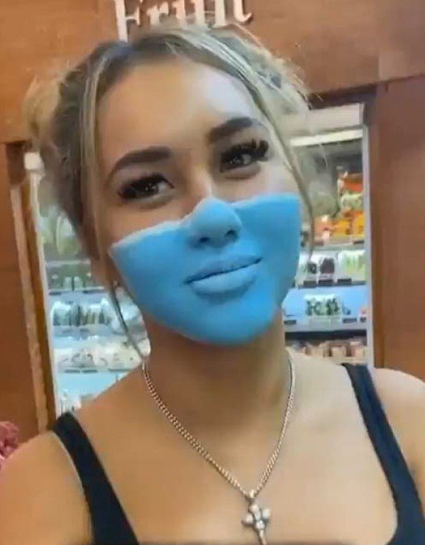 Leia Se showing off her painted on mask in the grocery store