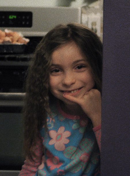Here I am, on my seventh birthday, in the kitchen of my childhood home