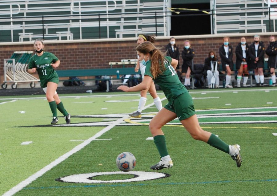 Freshman Gigi Sinicrope kicking the ball down the varsity field in hopes of another point for the Rangers. 