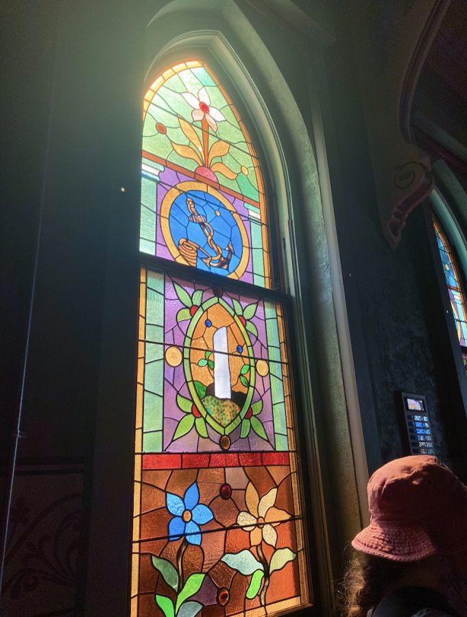 Sunlight coming through a stained glass window in a chapel in Charlevoix, feat Emmas bucket hat