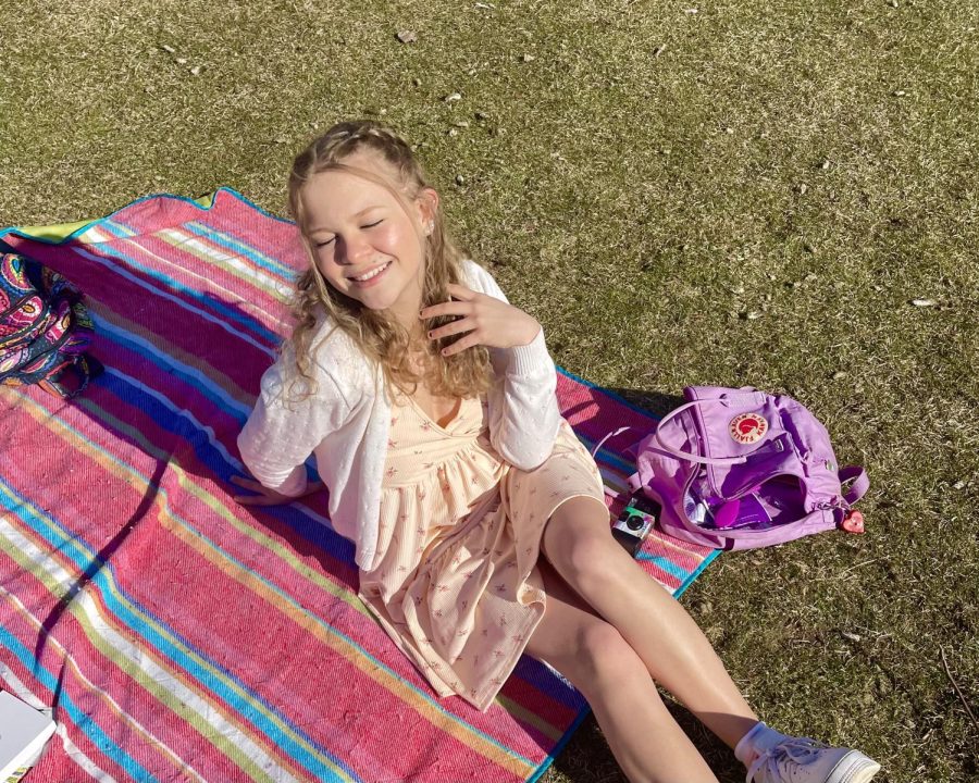 Savannah soaking up the sunshine at an outdoor picnic with friends.