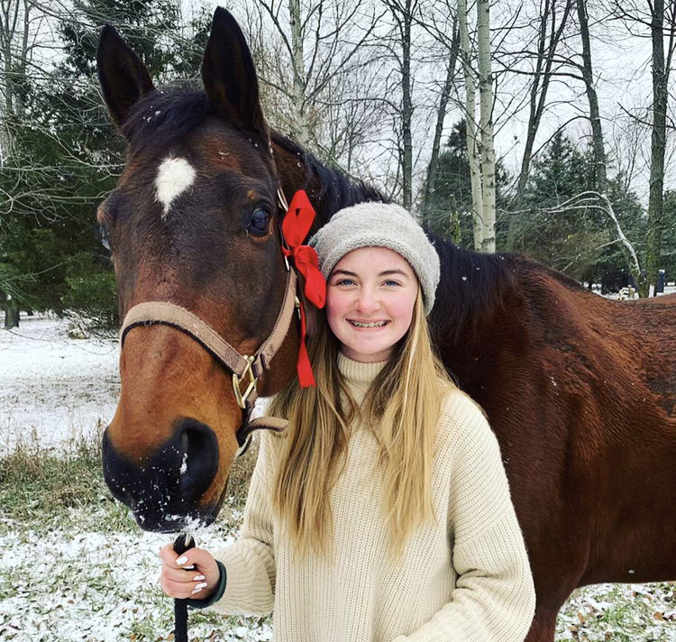 A snowy photo of freshman Ashely Hibma and her horse, Rylee. 