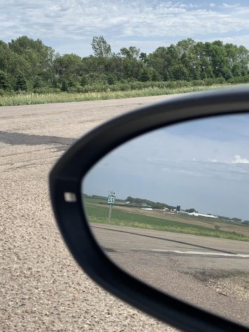 A picture of the farm my mom grew up on through one of the side mirrors of our car.