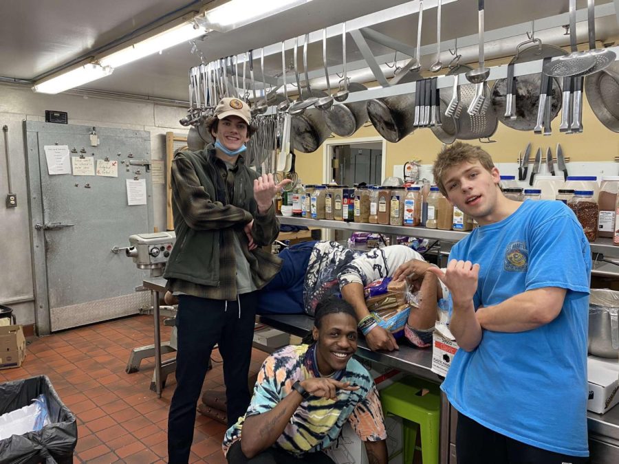 Cole (blue shirt) and his co-workers posing in the kitchen at Sentinel Pointe.