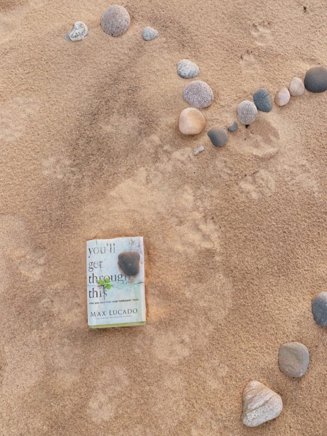 A picture I captured of a book that washed up onto Lake Superiors shore, surrounded in a heart of rocks.
