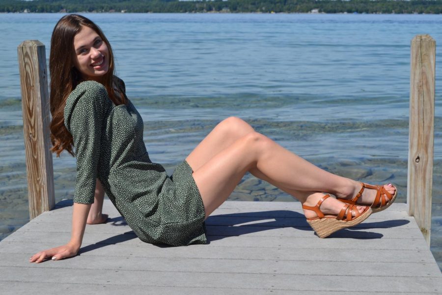 Katie soaks in the sunshine as she poses by Torch Lake near her cottage. 