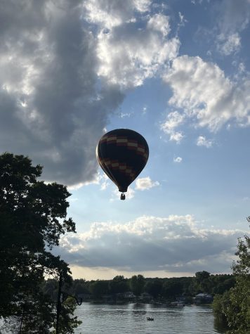 A hot air balloon flying over the lake by my house, getting insanely close to the water.
