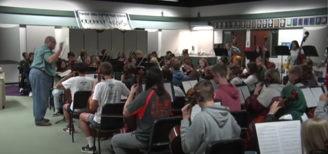 The FHC orchestra practices for a concert in the orchestra room