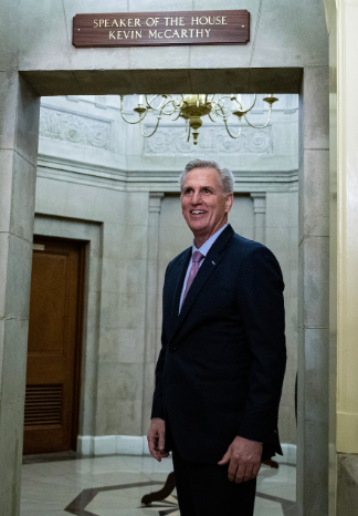 Speaker Kevin McCarthy under his Speaker of the House sign outside his office.
