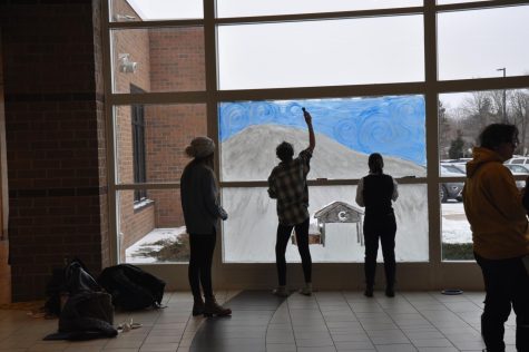 The start of 2022s Freshman class window painting, including Abby Schnelker