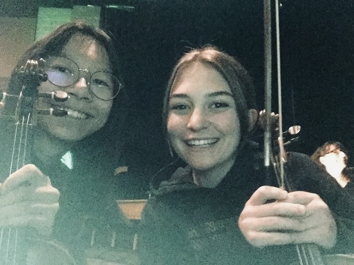 Abby Schnelker and senior Summer Wu are both a apart of the pit orchestra.