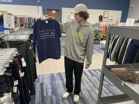 Liam Bennett at the thrift store adding new items to his closet.
