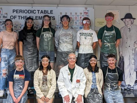 VonEhr and his AP Chemistry class pose in front of the periodic table with Albert Einstein while decked out in lab safety gear.