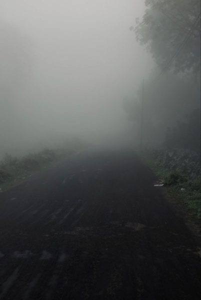 A dark, foggy road 