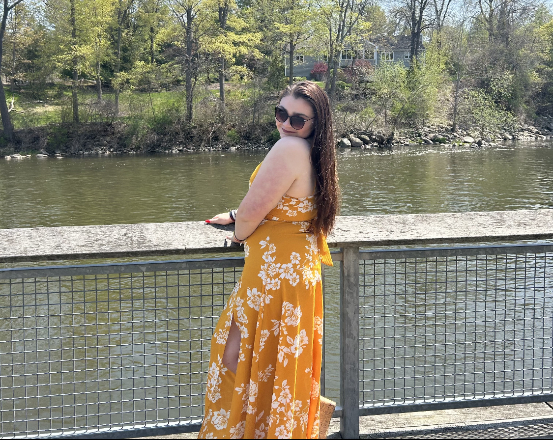 Senior Katy Dykstra standing by a river on a sunny day.