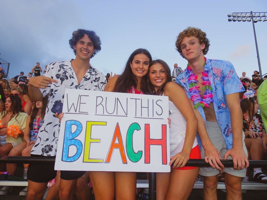 From left to right: Charlie Afman, Sloane Corey, Gigi Sinicrope, and Jonas VanderWoude. The four student section leaders at the Hawaiian-out game.