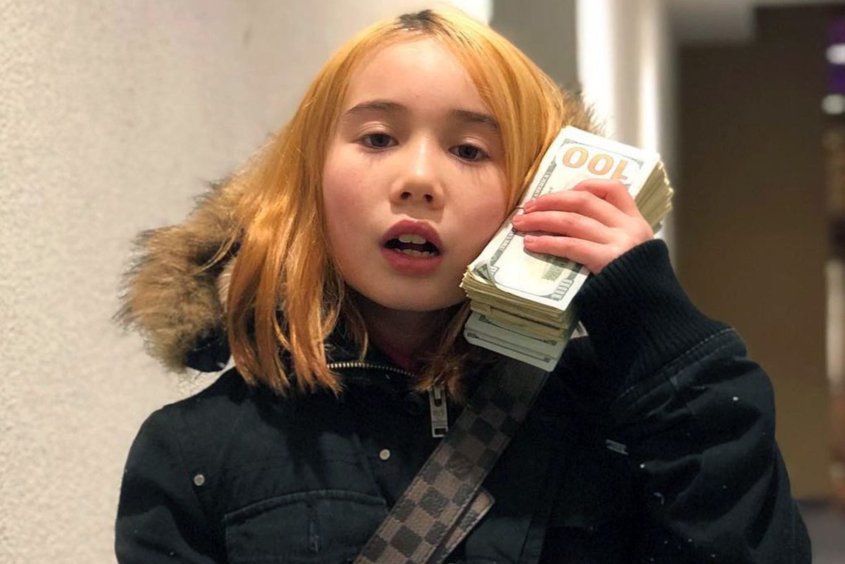 A picture of 9-year-old Lil Tay boastfully holding a stack of money. 