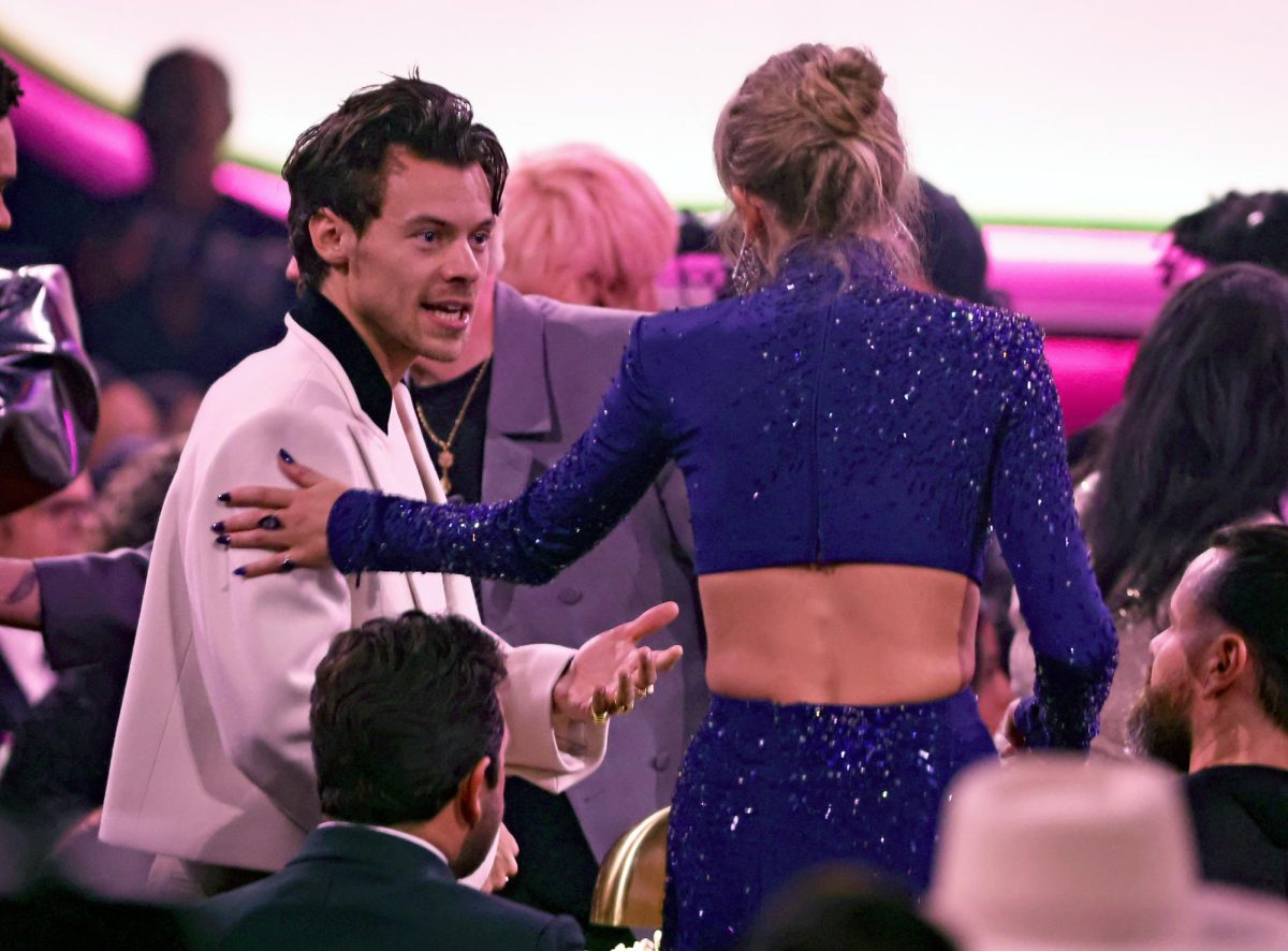 Taylor Swift and Harry Styles talking at the Grammy Awards in 2023. 