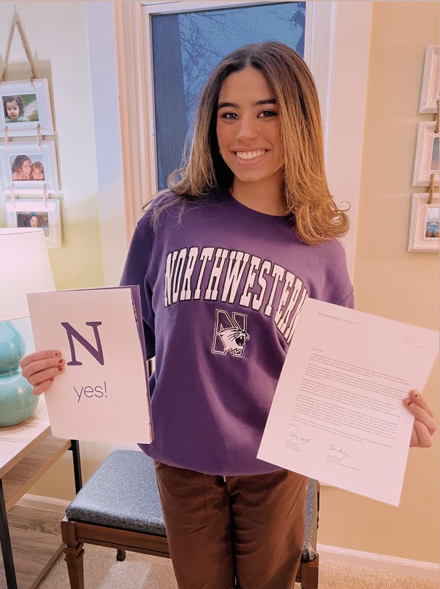 This is me with my acceptance letter to Northwestern University wearing my new favorite sweatshirt.