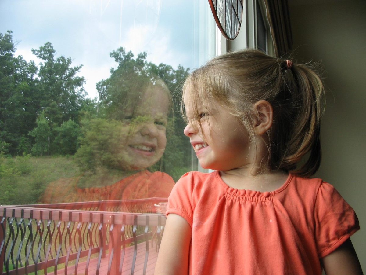 Two+year+old+me+smiling+at+my+reflection+in+the+window