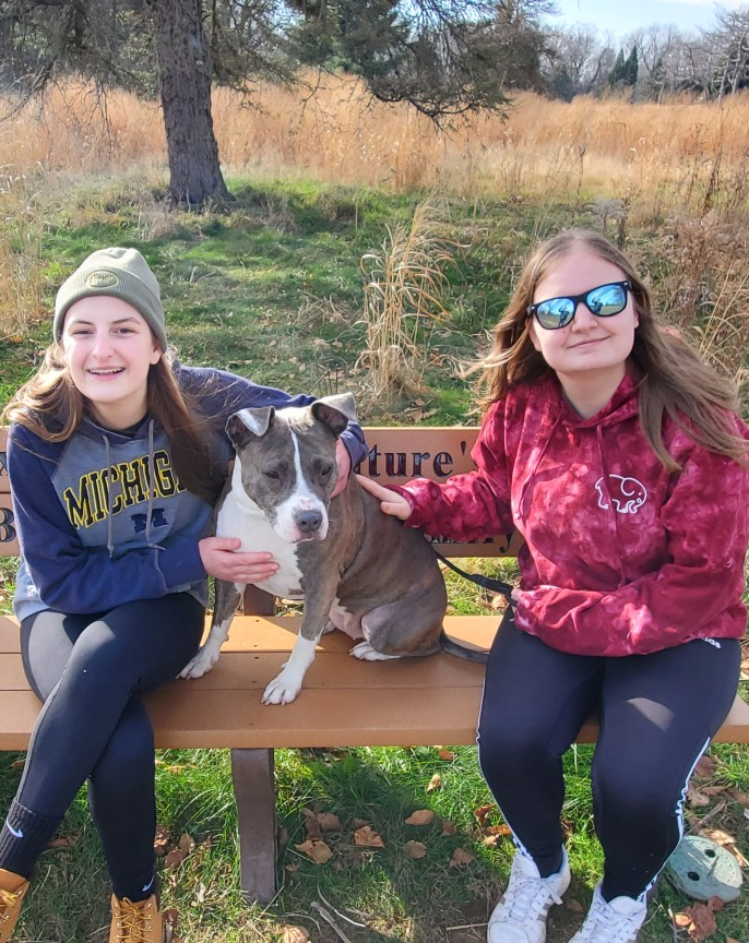 My sister and I (both neurodivergent) enjoying one of our favorite hobbies together: hanging out with shelter dogs.