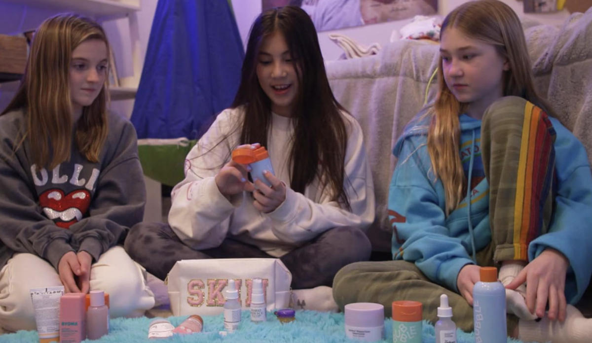 Three preteen girls going through their skincare routines together.