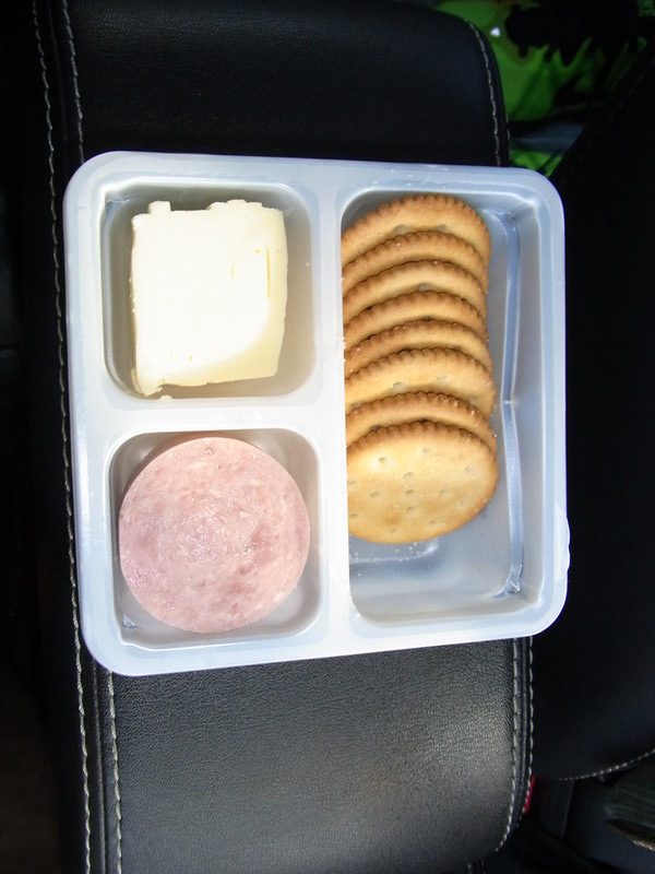 A photo of a Lunchable meal, including crackers, swiss cheese, and ham.
