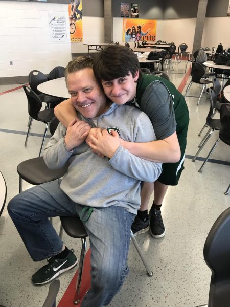 Principal Steve Passinault hugging a student from when he coached our Special Olympics.