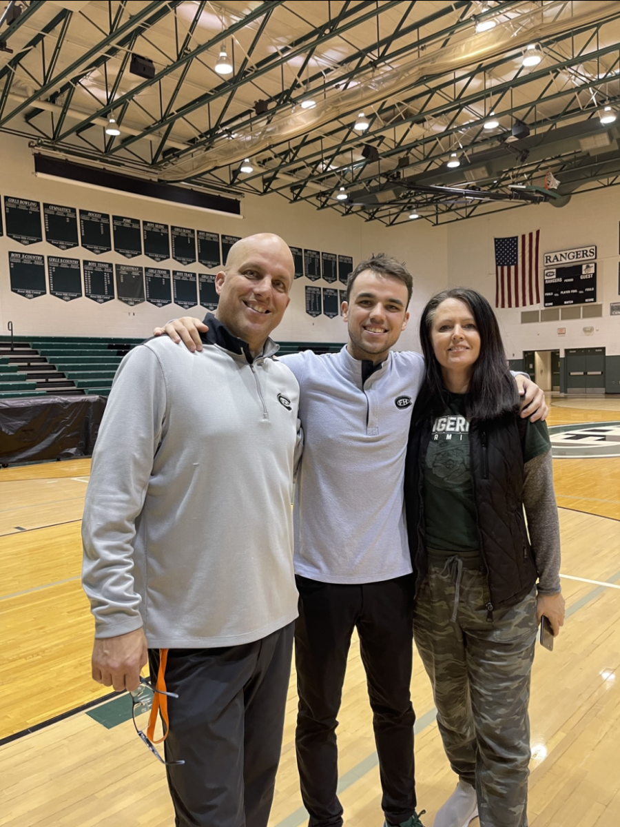 Jordan George stands with his father, a veteran in English teaching, coaching varsity basketball, and being the advisor for The Central Trend.