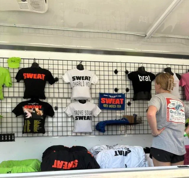 A booth containing the Sweat Tour merchandise for sale outside of the arena. 