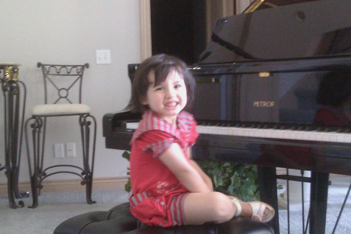 A picture of me when I was two, looking happy as a clam on the grand piano chair.