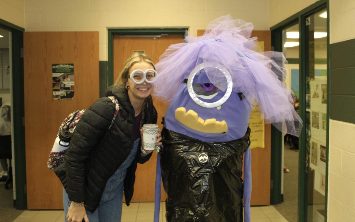 Graduated senior TZ Cumbo-Nacheli dressed up at school with a purple minion from Despicable Me. 