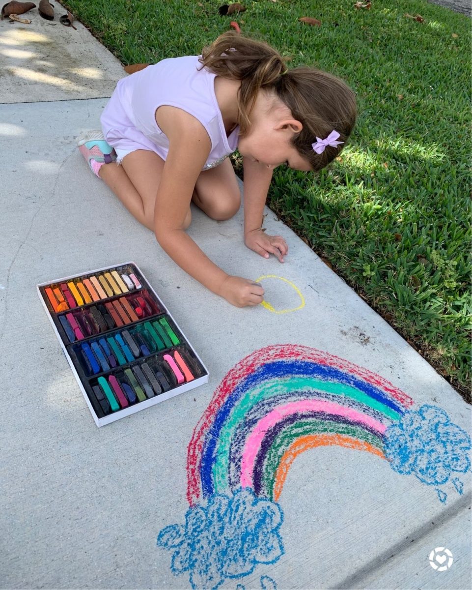 An example of a child you could potentially babysit coloring with chalk.