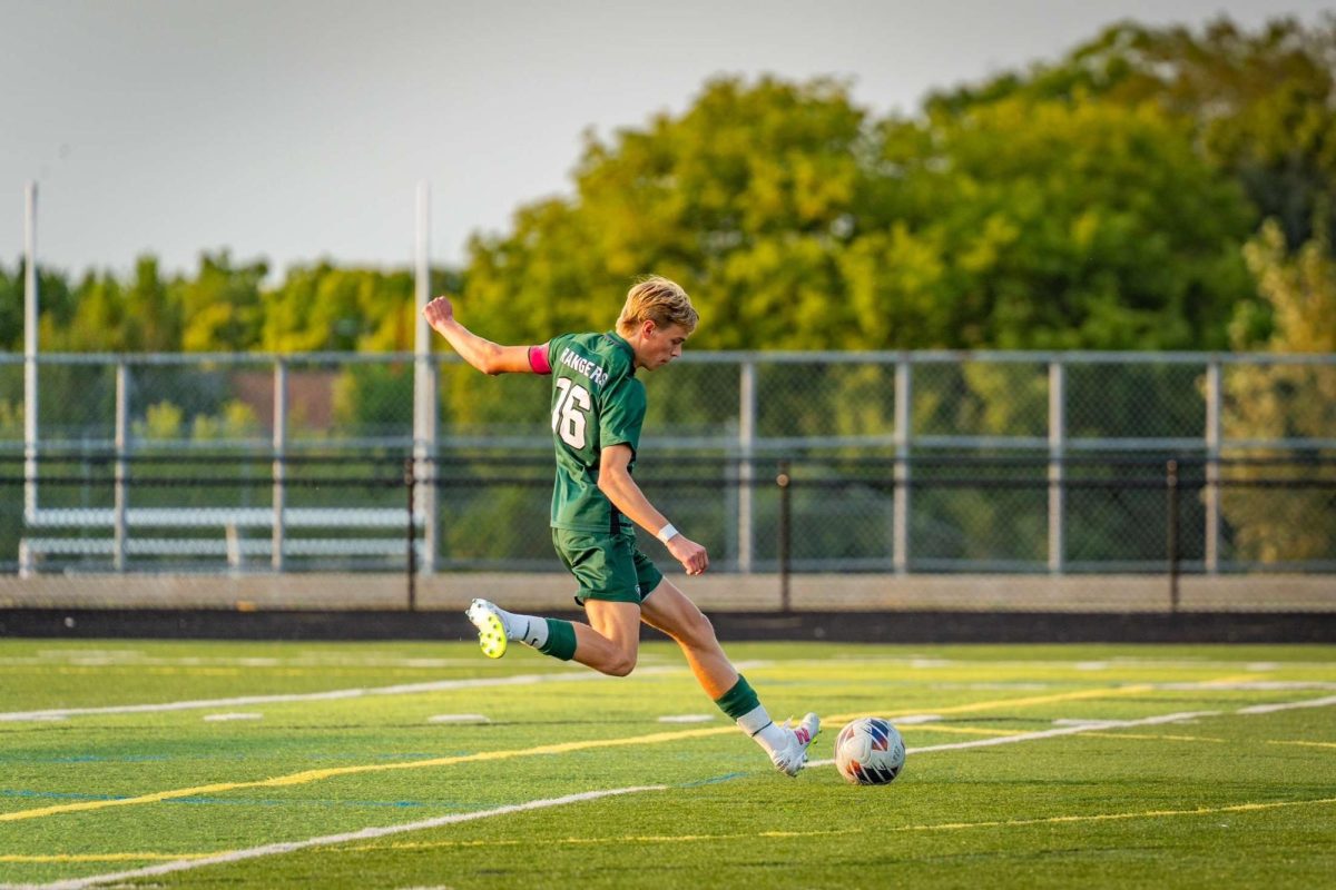 Micah striking a hit on the ball during a game. 