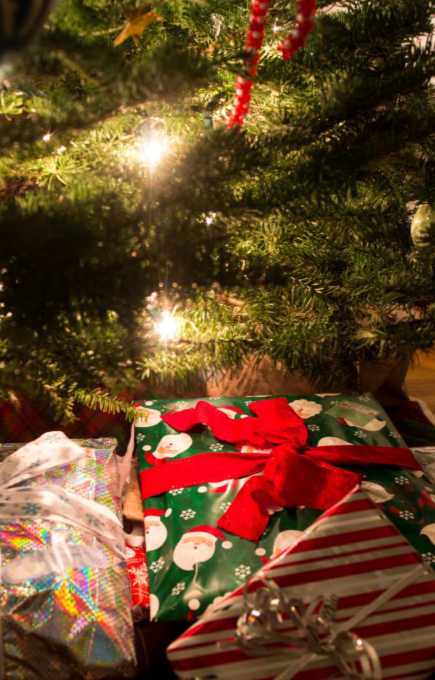 Christmas gifts stacked under a tree, waiting to be opened.