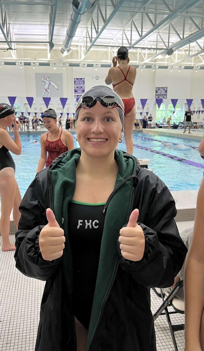 Allison Meny standing by the pool during a swim meet.