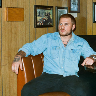 A champion of bare-bones acoustic Americana, Bryan released his first album, "DeAnn," in 2019 while still in the Navy. 